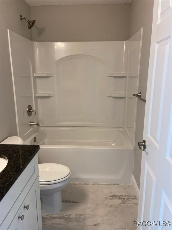 full bathroom featuring shower / bath combination, vanity, and toilet