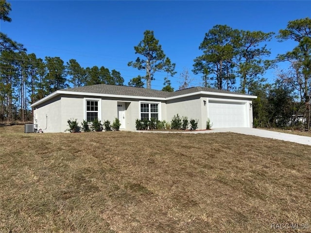 ranch-style home with cooling unit, a garage, and a front yard