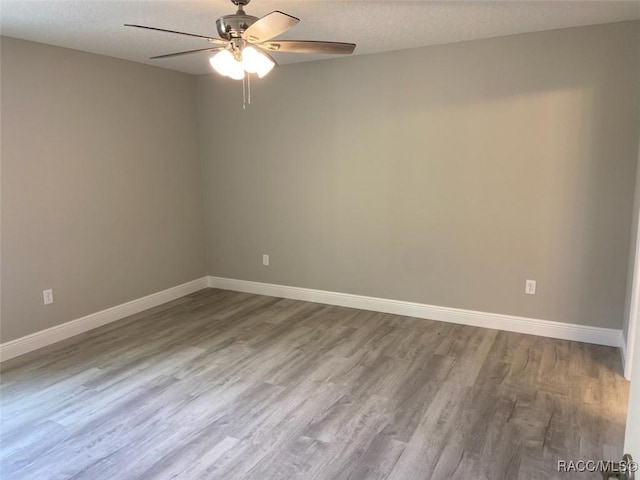 empty room featuring wood-type flooring, a textured ceiling, and ceiling fan