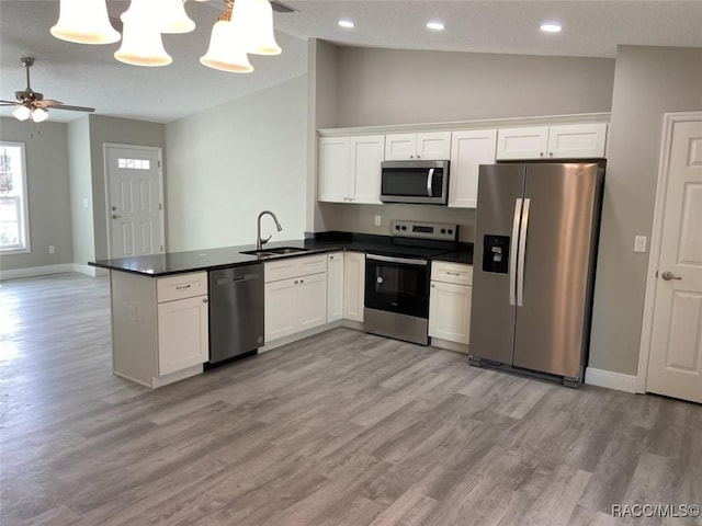 kitchen with sink, stainless steel appliances, and white cabinets