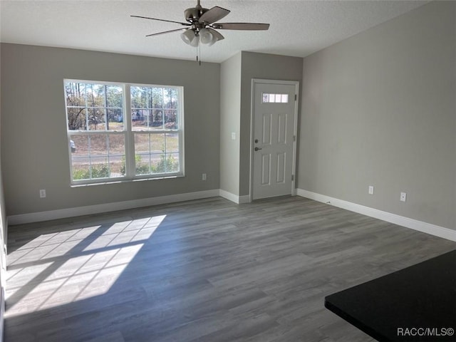 entryway featuring ceiling fan, hardwood / wood-style floors, and a textured ceiling