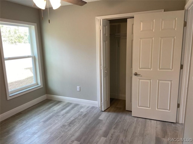 unfurnished bedroom with a closet and light wood-type flooring