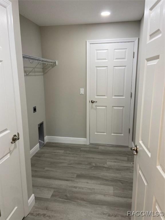 washroom featuring hookup for an electric dryer and dark hardwood / wood-style flooring