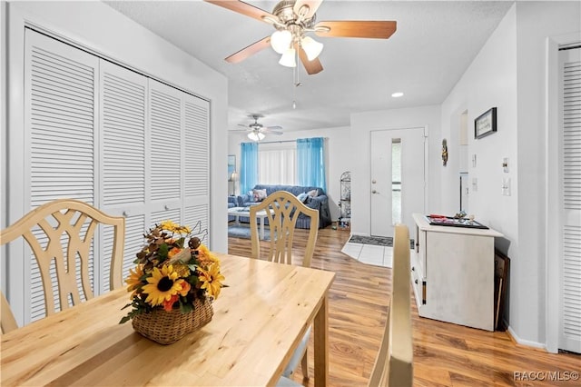 dining room with light wood-type flooring and ceiling fan