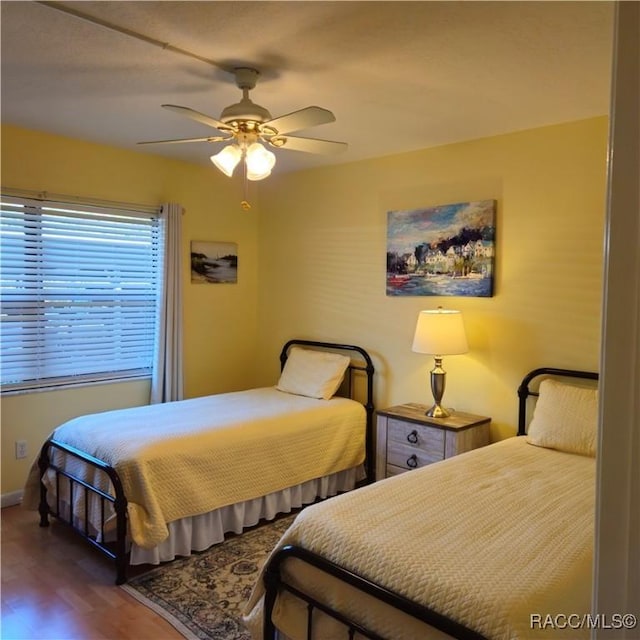 bedroom with hardwood / wood-style flooring and ceiling fan