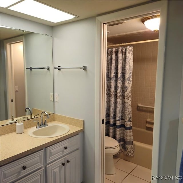 full bathroom featuring tile patterned flooring, vanity, shower / bath combo, and toilet