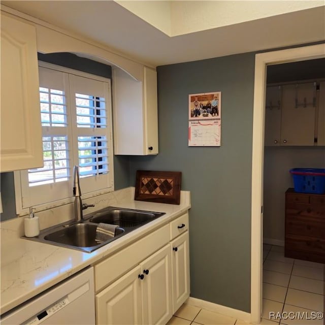 kitchen featuring white cabinetry, dishwasher, sink, and light tile patterned floors