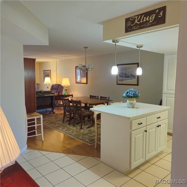 kitchen with an inviting chandelier, hanging light fixtures, and light tile patterned floors