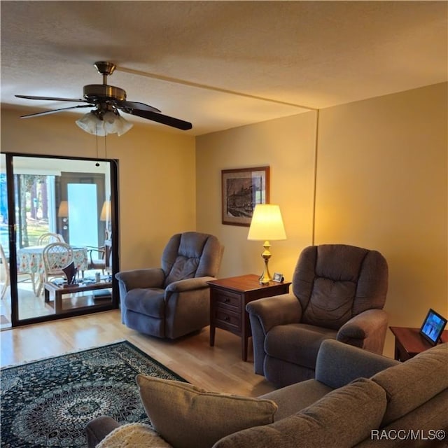 living room featuring hardwood / wood-style flooring and ceiling fan