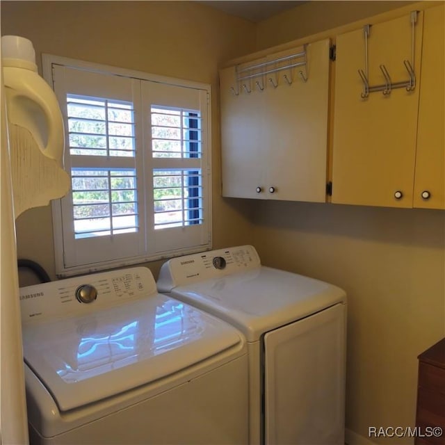 laundry area featuring cabinets and washer and dryer