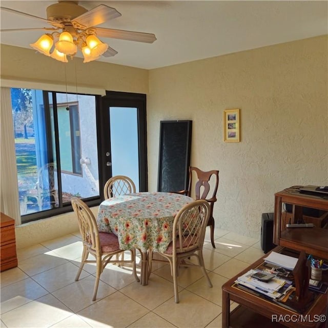 tiled dining room with ceiling fan