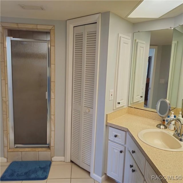 bathroom featuring an enclosed shower, vanity, and tile patterned floors