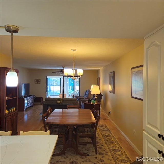 dining room with dark hardwood / wood-style floors and a notable chandelier