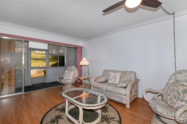 living room featuring crown molding, a textured ceiling, and hardwood / wood-style flooring