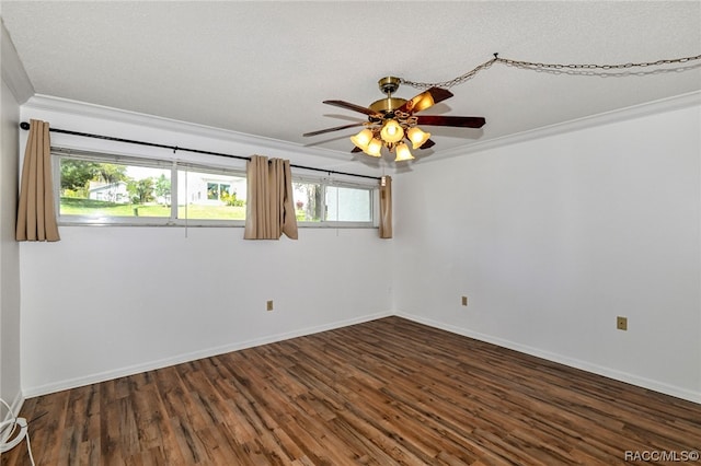 empty room featuring plenty of natural light, dark hardwood / wood-style flooring, ornamental molding, and a textured ceiling