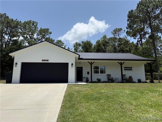 5476 W Paul Bryant Dr, Crystal River, FL 34429 - view of front of property featuring a garage, stucco siding, a front yard, and driveway