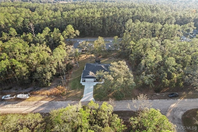 aerial view of property and surrounding area with a forest