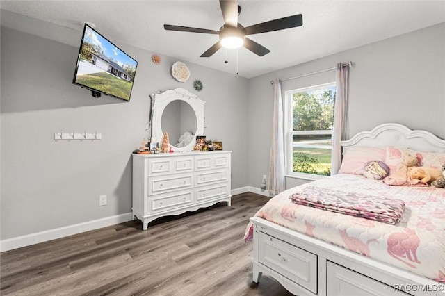 bedroom with wood finished floors, baseboards, and a ceiling fan