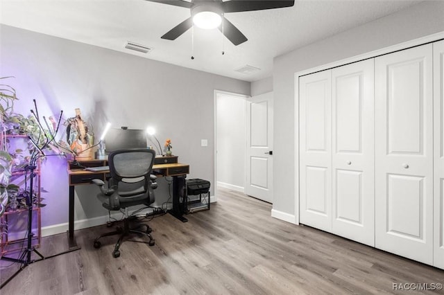 home office featuring a ceiling fan, wood finished floors, and baseboards