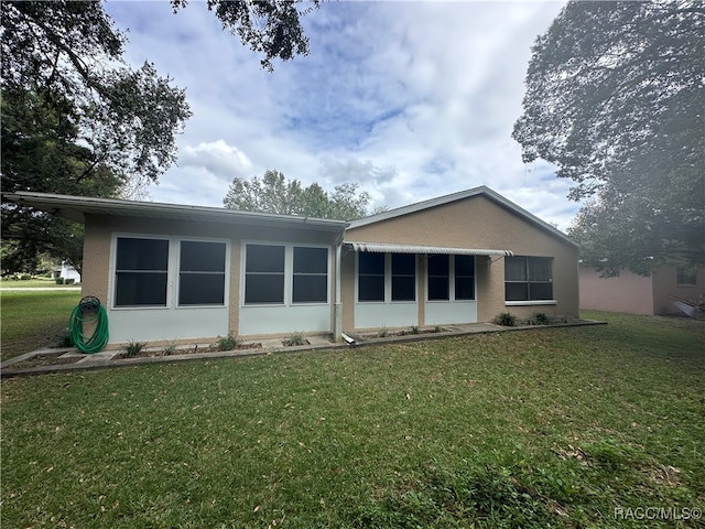 back of house with a yard