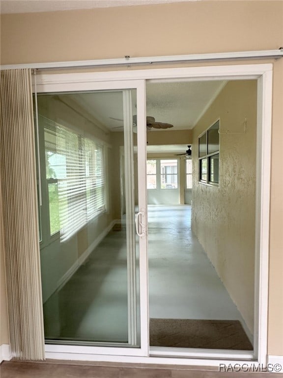 doorway to outside with ceiling fan