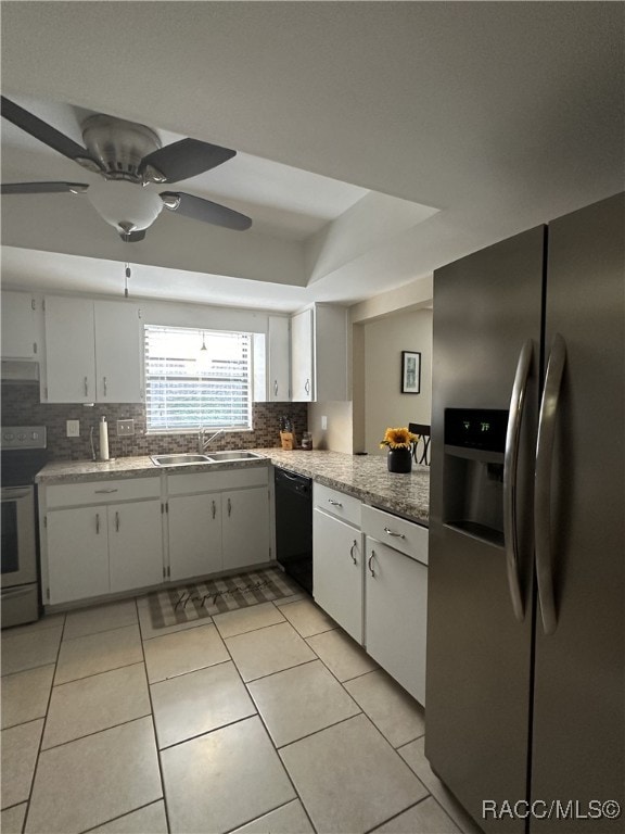 kitchen with sink, stainless steel appliances, white cabinets, backsplash, and light tile patterned flooring