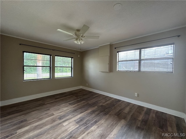 unfurnished room with a textured ceiling, ceiling fan, dark wood-type flooring, and a wealth of natural light