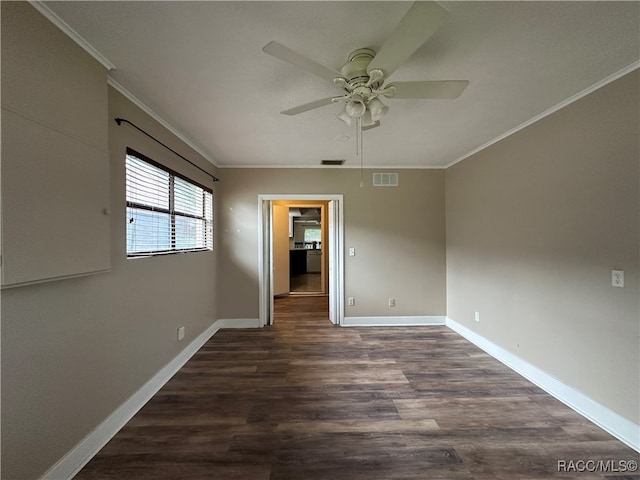 empty room with dark hardwood / wood-style flooring, ceiling fan, and crown molding