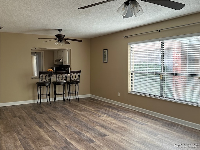 spare room with hardwood / wood-style floors and a textured ceiling