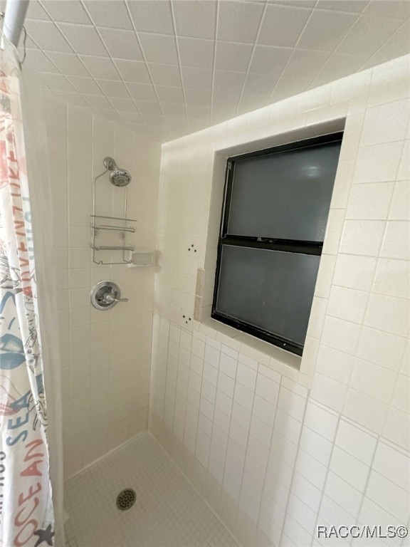 bathroom with a shower with shower curtain