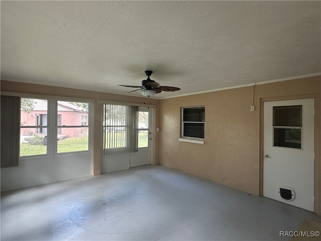 unfurnished sunroom featuring ceiling fan