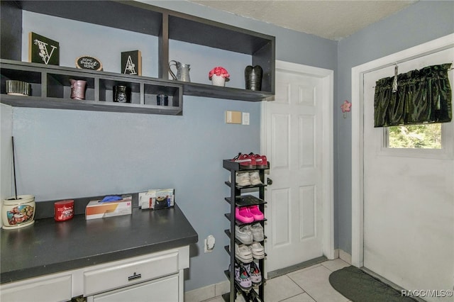 kitchen featuring white cabinets and light tile patterned floors