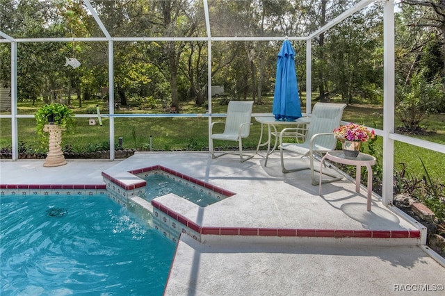 view of pool featuring glass enclosure, a patio area, and an in ground hot tub