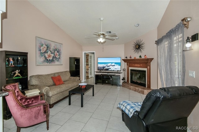 tiled living room with ceiling fan and lofted ceiling