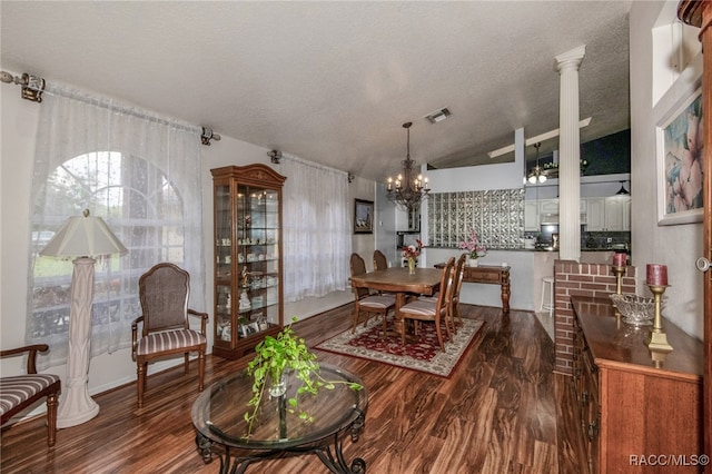 dining room with ceiling fan with notable chandelier, a textured ceiling, dark hardwood / wood-style flooring, and lofted ceiling