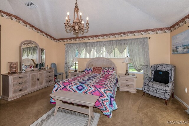 carpeted bedroom with an inviting chandelier