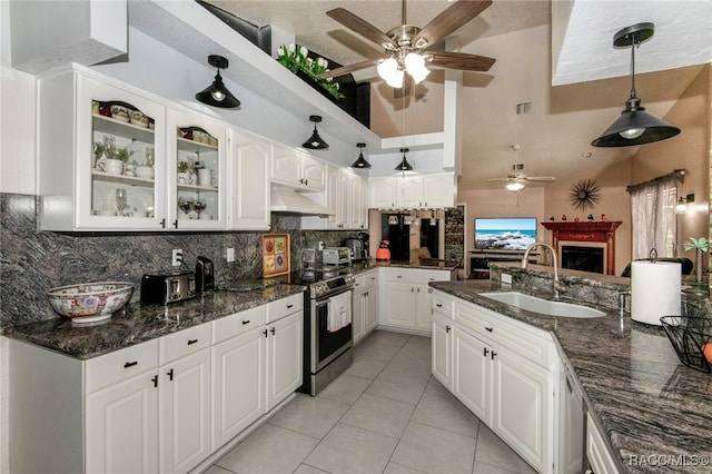 kitchen with stainless steel range with electric stovetop, decorative light fixtures, white cabinetry, and sink