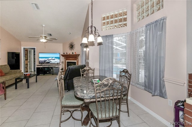 dining area featuring light tile patterned floors and ceiling fan with notable chandelier