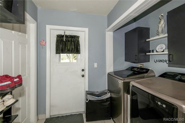 laundry area with a textured ceiling and washer and clothes dryer