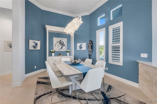 dining space featuring an inviting chandelier, light wood-type flooring, and ornamental molding