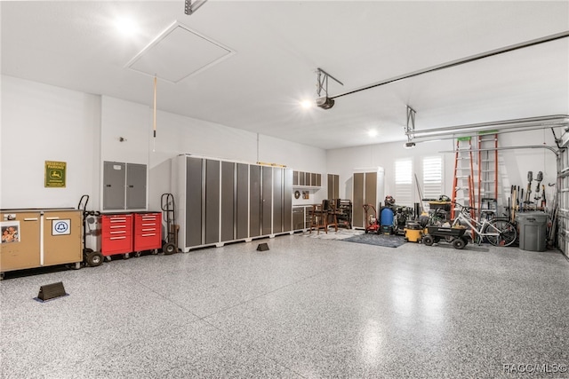 garage with electric panel and a garage door opener