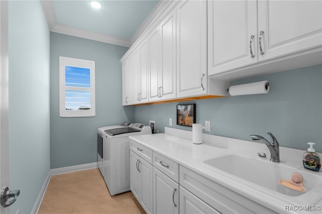 laundry room featuring cabinets, washer and dryer, ornamental molding, and sink