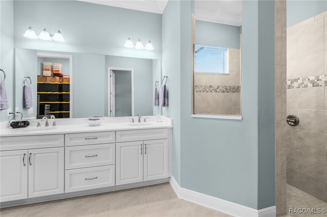 bathroom with a tile shower, tile patterned floors, vanity, and ornamental molding