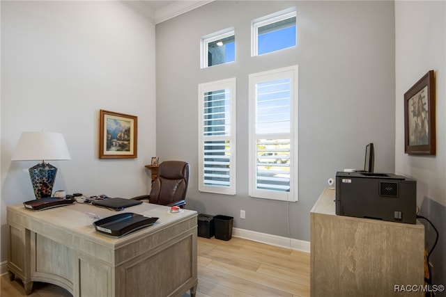 office space with light hardwood / wood-style floors and ornamental molding