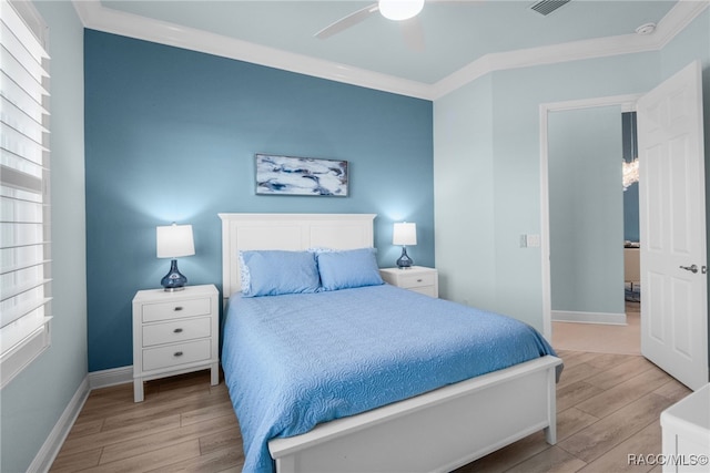 bedroom with ceiling fan, ornamental molding, and multiple windows