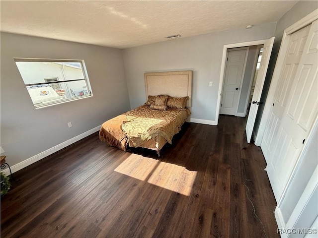 bedroom with a closet and dark wood-type flooring