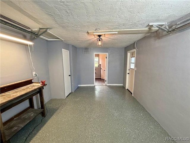 hall featuring a textured ceiling