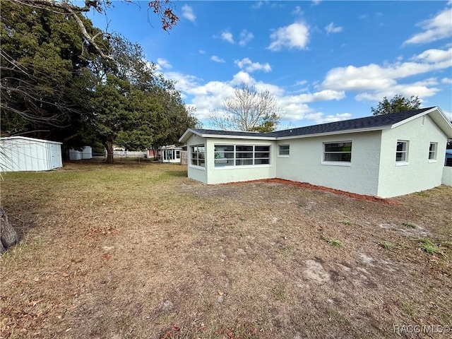 rear view of house with a lawn