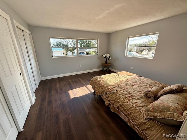 bedroom with dark wood-type flooring