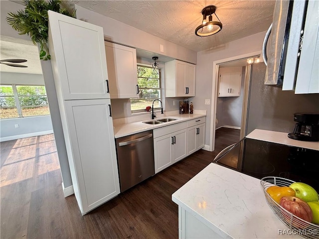 kitchen with white cabinetry, stainless steel dishwasher, plenty of natural light, and sink